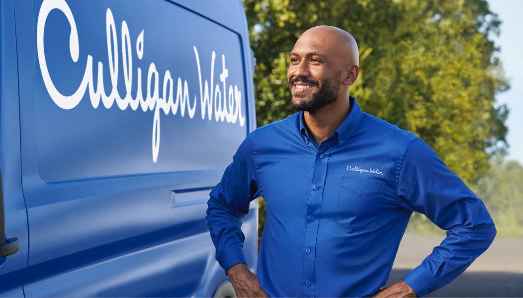 Culligan expert standing near van